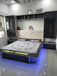 The low wooden bed has natural lines and prints on it. Wood Simple Design Modern Bedroom Wood Simple Design Bedroom Furniture Trendecors