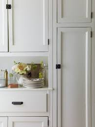 White shaker cabinets like the dayton (shown above) offer sleek style while opening up this kitchen's space. Calm And Collected At Home With The Duo Behind Aesthetic Movement Remodelista Black Kitchen Cabinets Kitchen Renovation Black Hardware Kitchen