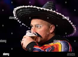 A fan takes a drink during the 2023 Cazoo PDC Premier League Darts Night 6  at M&S Bank Arena, Liverpool, United Kingdom, 9th March 2023 (Photo by Phil  Bryan/News Images Stock Photo