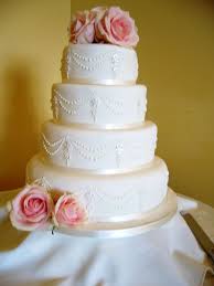 Four Tier Ivory Wedding Cake With Oval Plaques Hand Piping And Finished With Fresh Pink Roses Wedding Cake Maker Garden Wedding Cake Wedding Cakes