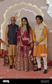 Mumbai, India. 12th July, 2024. Bollywood actress Juhi Chawla (C) pose for  a photo with her husband Jay Mehta (L) and son Arjun Mehta (R) on the red  carpet wedding ceremony of
