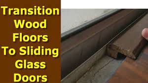 Place the screwdriver beneath the threshold edge, flat against the floor and pry the wood gently up, taking care not to gouge the floor's surface. How To Transition Wood Floors To Sliding Glass Doors And Tile Youtube