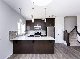 A Beautiful White Kitchen With Dark Brown Cabinets Gray Floors And Lovely Ba Dark Brown Cabinets Kitchen With Dark Brown Cabinets Dark Brown Kitchen Cabinets