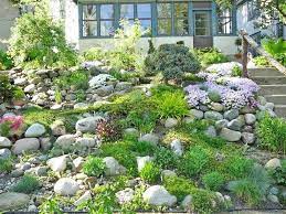 How To Landscape A Sloped Yard Sloped Garden Hillside Landscaping Rock Garden Landscaping