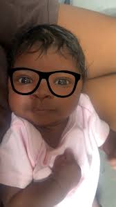 older sibling taking pictures of baby