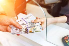 Picture of money changing hands. Man Changes Money In A Currency Exchange A Large Sum Of Dollars An Increase In The Exchange Rate 359121826 Larastock