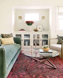 Grey master bedroom boasts silver grayw alls lined with white tufted headboard on queen bed dressed in white and gray ribbon bedding and white and gray monogram shams layered over gray shams beside a mirrored nightstand topped with cream. Red Velvet Sofa Design Ideas