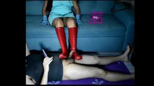 Butcher Mistress is back now for squeeze the slave cock until cumshot! with  her new red rubber boots