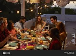 At a large dinner party the guests were discussing a typical behaviour of people when they were in some crisis. Friends Talking Dinner Image Photo Free Trial Bigstock