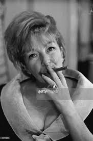 Actress Beryl Reid learning to smoke a cigar for her role in 'The...