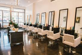 There are multiple hairdressing chairs/workstations in this trendy unisex salon, and the products on sale are well displayed. Salon V Nyc Hair Salon Hair Color Hair Services