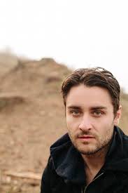 A Caucasian Man Looking At The Camera Wearing A Black Jacket" by Stocksy  Contributor "J Danielle Wehunt"