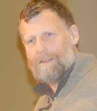 Dandelion clocks wait for the wind to sow them