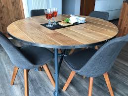 Modern dining room with round dining table and upholstered dining chairs in this modern gold and white dining room. Solid Oak Round Dining Table Industrial Barrel Top Style Steel Edge With Black Coach Screw Detailing And Hea Industrial Style Dining Table Dining Table Table