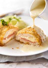 Wrap the chicken in the plastic wrap, twist the excess plastic, and roll the chicken while twisting the sides in to tighten and firm up the roll of chicken cordon bleu. Chicken Cordon Bleu Recipetin Eats