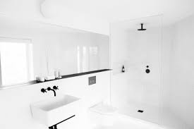 Incorporating a few dark accents and a soft transition color (like the pale gray in the shower) is a good way to add some dimension to the bathroom. 10 Minimalist Bathrooms Of Our Dreams