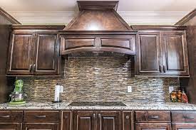 The contemporary kitchen in the picture above features stainless steel appliances which can easily be integrated with the neutral dark brown cabinets and white quartz counter. Kitchen Tile Image Galleries For Inspiration