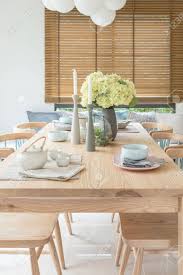 The handmade bowl boasts a sleek silhouette and deep basin fit for florals and fruit displays alike. Wooden Dining Table In Modern Dining Room With Table Set And Vase Of Plants Interior Design Concept Stock Photo Picture And Royalty Free Image Image 80198552