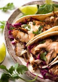 The vibrant orange sriracha mayo contrasted with a deep indigo colored taco shell. Fish Tacos Recipe In 2020 Recipetin Eats Recipes Best Fish Taco Recipe