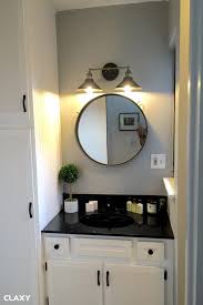 To avoid dark spots at a long vanity, consider mounting a dual sconce in the center with single sconces at the outer edges of the mirrors and vanity. Bathroom Lighting Over Round Mirror Trendecors