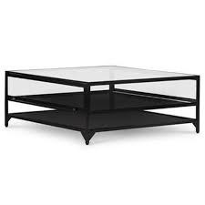 The coffee table's fluted, tapered legs are finished with decorative floral pucks resting under a gorgeous glass top. Allen Industrial Loft Tempered Glass Top Black Iron Square Coffee Table 31 W 40 W Kathy Kuo Home