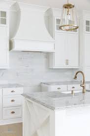 Bianco carrara floor, vanity in benjamin moore pigeon gray, bianco statuario countertop, kohler fairfax lavatory faucets, pottery barn mercer sconce, benjamin moore chantilly lace, west elm stripe shower curtain in feather gray, stacked 4x16 white subway tiles carrara border. 30 Beautiful Cabinet Paint Colors For Kitchens And Baths
