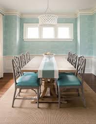 The bench is straight out of a country cottage. Gray Bamboo Dining Chairs With Turquoise Blue Leather Seat Cushions Flank A Trestle Dining Table And C Aqua Dining Rooms White Dining Room Bamboo Dining Chairs