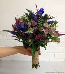 Rustic themes are all the rage. English Garden Just Picked Rustic Wedding Bridal Bouquet With Blue Delphinium Eryngium Astrant Rustic Wedding Flowers Wedding Bridal Bouquets Wedding Flowers