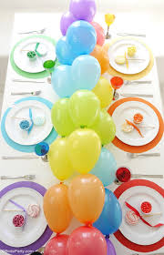 Mini balloons are placed on cups and sticks. Rainbow Tablescape Diy Balloon Garland Party Ideas Party Printables Blog