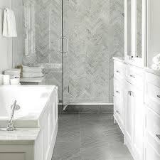You will never find two marble surfaces that look exactly the same. Brass Lantern Over Tub And Gray Porcelain Floor Tiles Transitional Bathroom