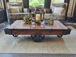 This coffee table sits lower than traditional coffee tables. Early 1900 S Reclaimed Factory Cart Coffee Table Etsy In 2021 Cart Coffee Table Rustic Industrial Coffee Table Coffee Table Farmhouse