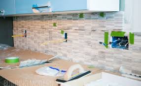 Use your pencil line and bubble level to line the tile up in the middle of the backsplash, before pushing it into the mastic. How To Install Stone Mosaic Tile Backsplash In Kitchen