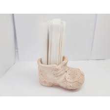 It has brown trim, with a pink flower on the front. Handmade Concrete Toothpick Holder In The Shape Of A Shoe
