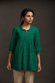 This Forest Green Crepe Tunic Has A Peter Pan Collar A Curved Yoke And Gathers At The Waist Facing At The Neck Fancy Tops Blouse Design Models Blouse Designs