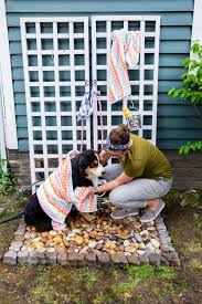 Many dog washing tubs have higher legs supporting the tub so the dog is level with your chest instead of you bending down on the hard bathroom floor to their level. Diy Outdoor Dog Shower Hgtv