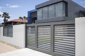 If you're looking to combine the sleek look of aluminium with the contemporary style of modern materials, share your vision with our experts and we will bring your vision to life with a custom gate design. The Aluminium Horizontal Louvre Sliding Gate Really Sets Off This Modern Home Get A Quote For Your A House Gate Design Entrance Gates Design Front Gate Design