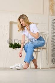 Taking a stable position is readying the body in case the other person attacks and can be a cautious position. Woman Leans Forward To Raise Her Shoes Stock Photo Crushpixel