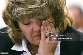 Wanda Blevins sits next to a photograph of herself and her husband,... News  Photo