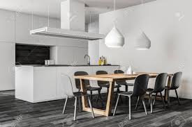 Even the beams and other details on the ceiling are white to brighten and create more space. White Wall Kitchen And Dining Room Corner With A Dark Wooden Stock Photo Picture And Royalty Free Image Image 106620522