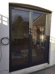 Bifold doors are made of two hinged panels, allowing them to collapse when opened. Cheshunt Two Panel Bi Fold Doors In Grey Fitted By Canon Windows