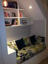 Squeeze In A Sofa Craving A Quiet Corner These Homeowners Have Designed A Reading Nook Complete With Mini S Under Stairs Nook Stair Nook Contemporary Hallway