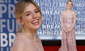 Sienna Miller flashes a winning smile at the Breakthrough Prize Gala