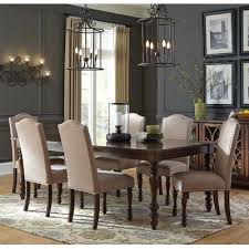 From Every Angle The Modern Traditional Design Of The Scoggins Collection Shines Through Offere Brown Dining Room Dining Room Chairs Formal Dining Room Table