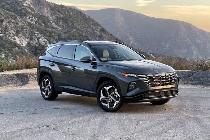 The 2022 Hyundai Tucson NX4 featuring its signature dark grey metallic finish., AI generated