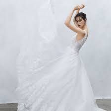 Young loving wedding couple in tent. New Alyne By Rita Vinieris Wedding Dresses Plus Past Collections