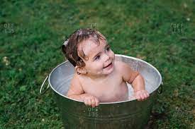 Free insulated bottle carrier ($16.95 value) free stroller hooks ($12.95 value) free shipping rated the #1 innovative diaper backpack bag by moms 2 years in a row! Smiling Baby Girl Taking A Bath In A Bucket Stock Photo Offset