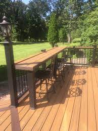 There's seating on the top and bottom levels, and storage beneath the deck for the couple's canoes. Pin By Brooke M On Bar Tops Deck Designs Backyard Backyard Backyard Patio