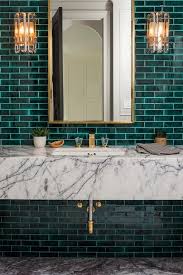 Art Deco Glass Sconces Mounted Against Emerald Green Subway Tiles Are Fixed On Either Side Of A Brass M Green Tile Bathroom Green Subway Tile White Marble Sink