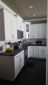 White Shaker Cabinets With Black Pearl Leathered Granite Glossy White Subway Tile And Dark Har Cottage Kitchen Cabinets Kitchen Cabinet Design Leather Granite