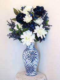Navy blue artificial flowers in vase. Silk Flower Arrangement With Large Blue And White Ceramic Vase With Dark Blue Peonies And White Dahlias Artificial Floral Arrangement Artificial Floral Arrangements Blue Flower Arrangements Flower Vases